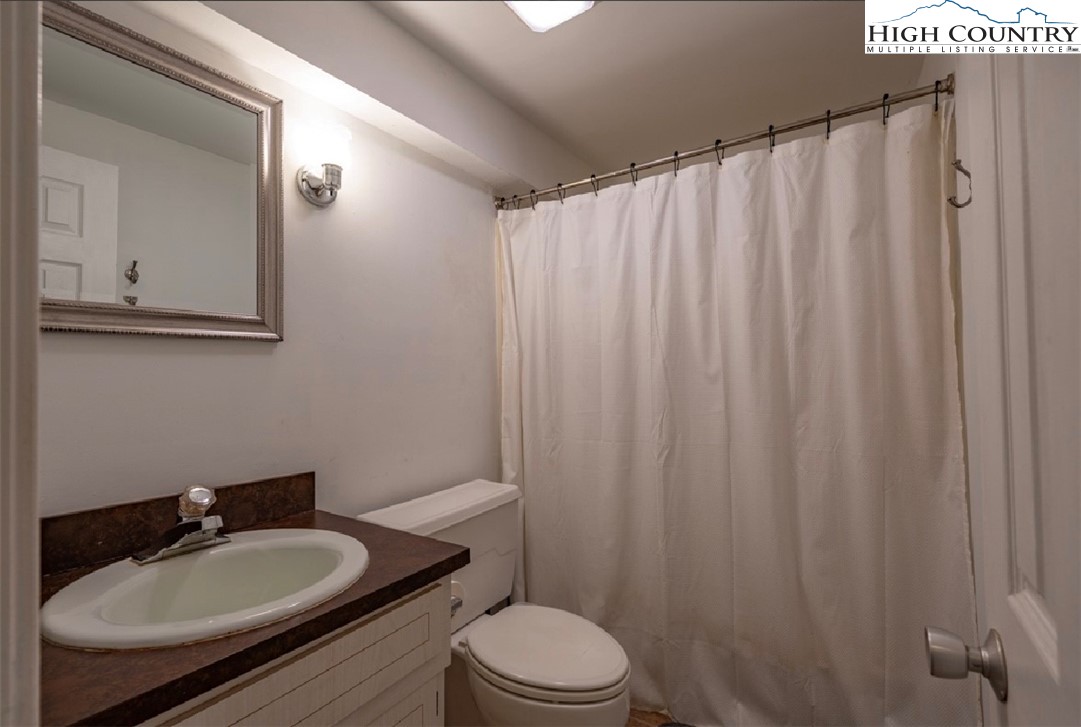 165 Briarcliff Road, Unit J42 Banner Elk, NC 28604 - Photo 20 of 20 a bathroom with a sink toilet a mirror and shower curtain