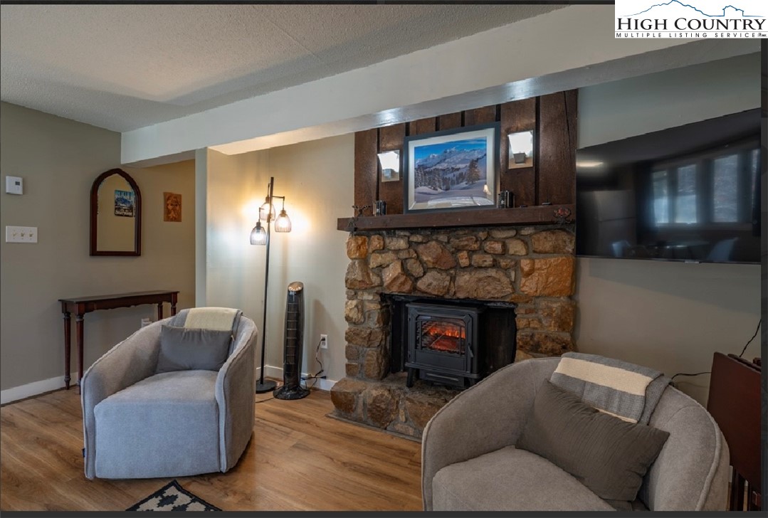 165 Briarcliff Road, Unit J42 Banner Elk, NC 28604 - Photo 4 of 20 a living room with furniture and a fireplace