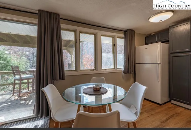 a dining room with furniture a window and a fireplace