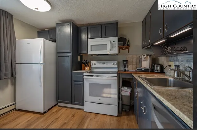 a kitchen with a refrigerator sink and microwave