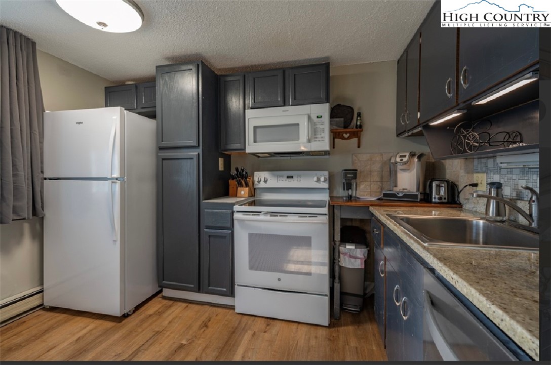 165 Briarcliff Road, Unit J42 Banner Elk, NC 28604 - Photo 9 of 20 a kitchen with a refrigerator sink and microwave