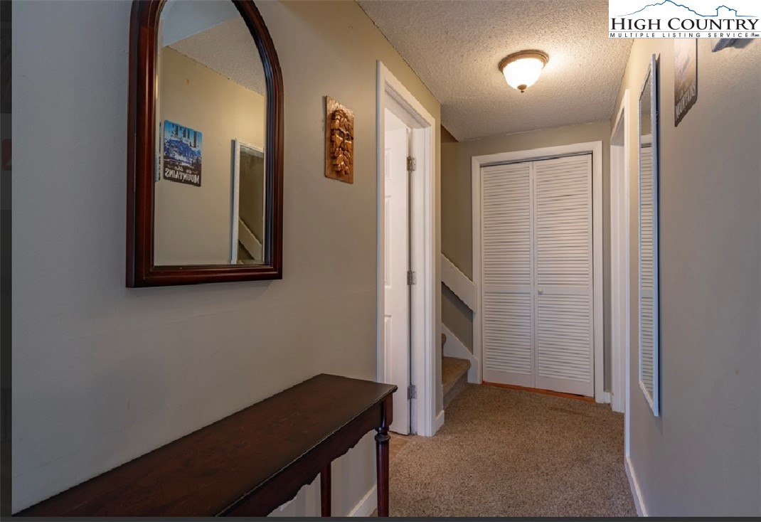 165 Briarcliff Road, Unit J42 Banner Elk, NC 28604 - Photo 10 of 20 a view of a hallway with paintings on the wall