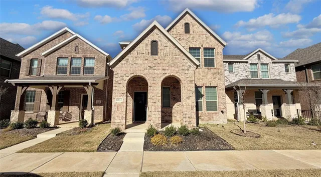 a view of a white house with large windows