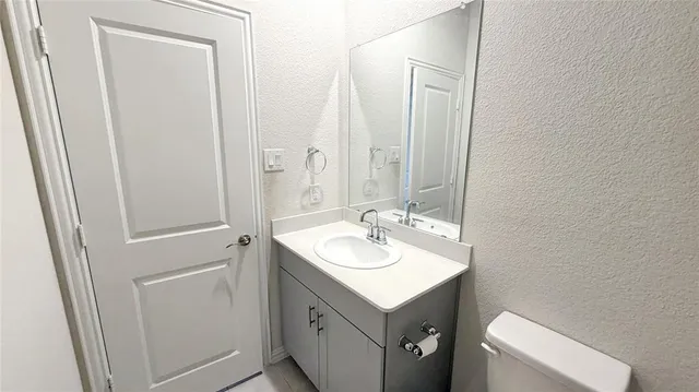 a bathroom with a sink toilet and mirror