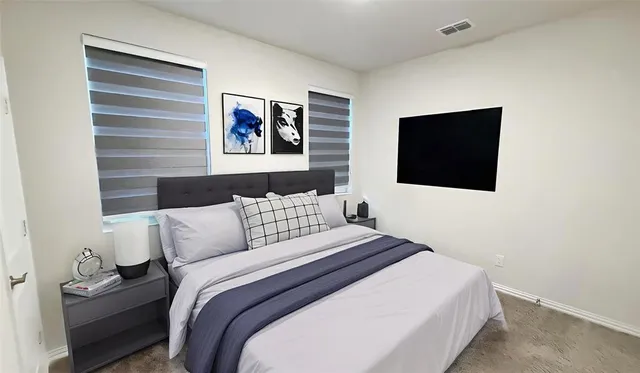 a bedroom with a bed and a flat screen tv