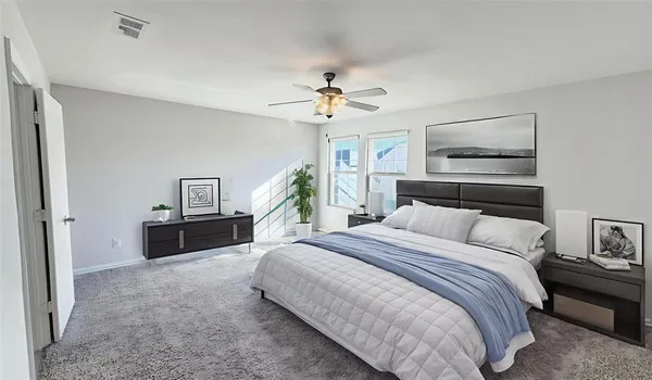 a spacious bedroom with a bed and a chandelier