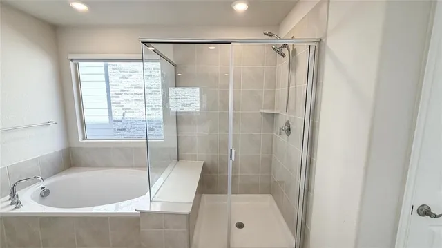 a bathroom with a bathtub and a shower