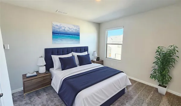 a bedroom with bed plant and window