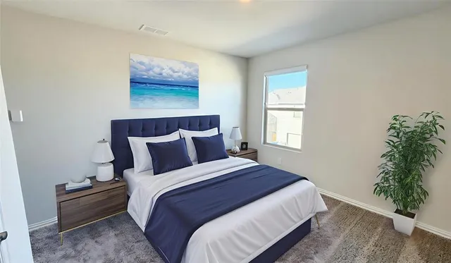 a bedroom with bed plant and window