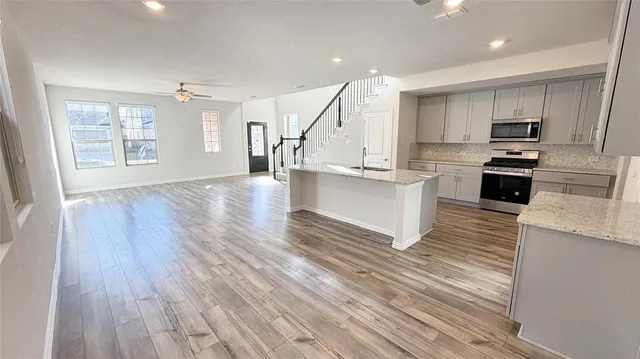 a kitchen with stainless steel appliances a stove top oven and cabinets