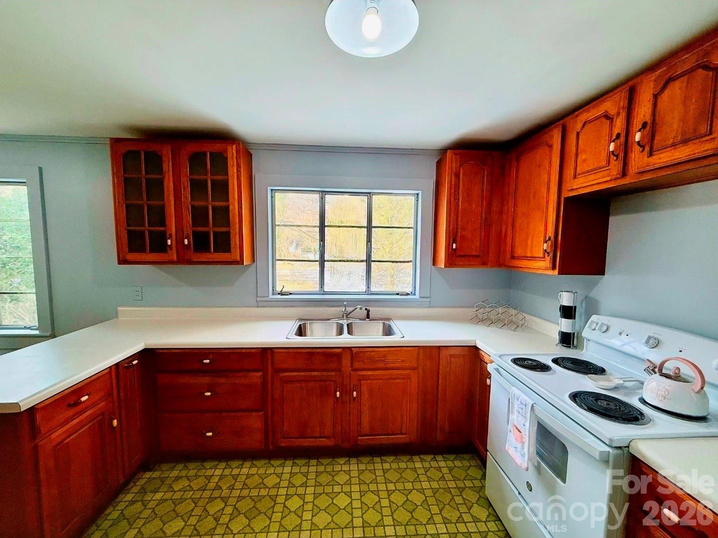 109 Wall Road Tryon, NC 28782 - Photo 12 of 30 a kitchen with a sink window and cabinets