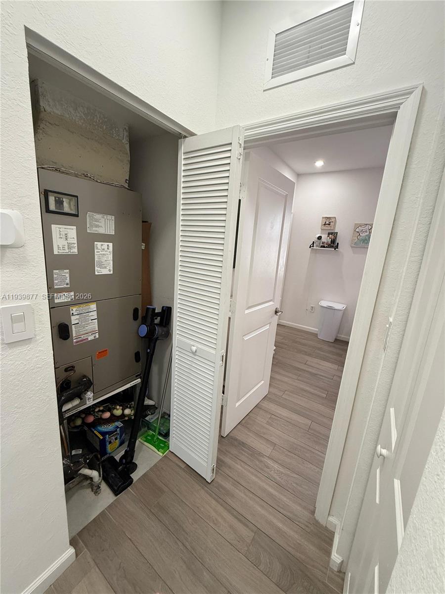 10066 Southwest 228th Terrace Miami, FL 33190 - Photo 11 of 42 a room with wooden floor and furniture