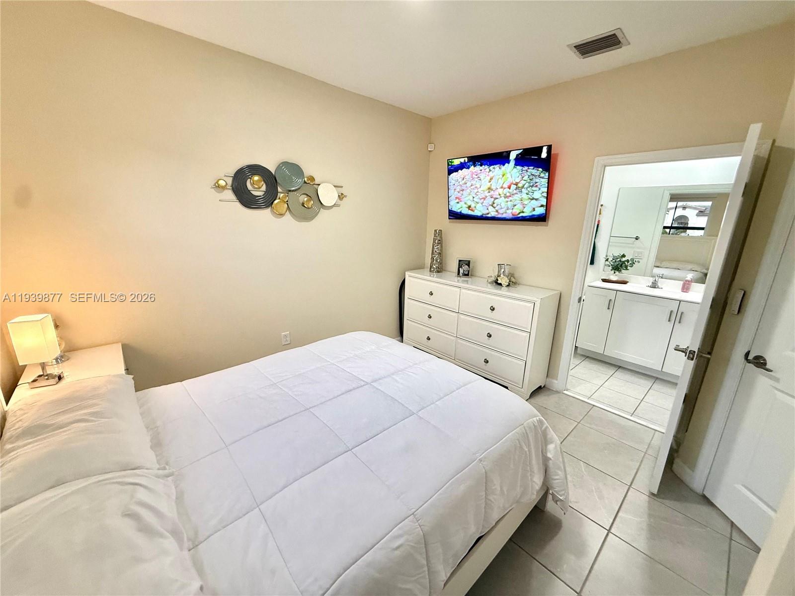 10066 Southwest 228th Terrace Miami, FL 33190 - Photo 13 of 42 a bedroom with a bed and a dresser