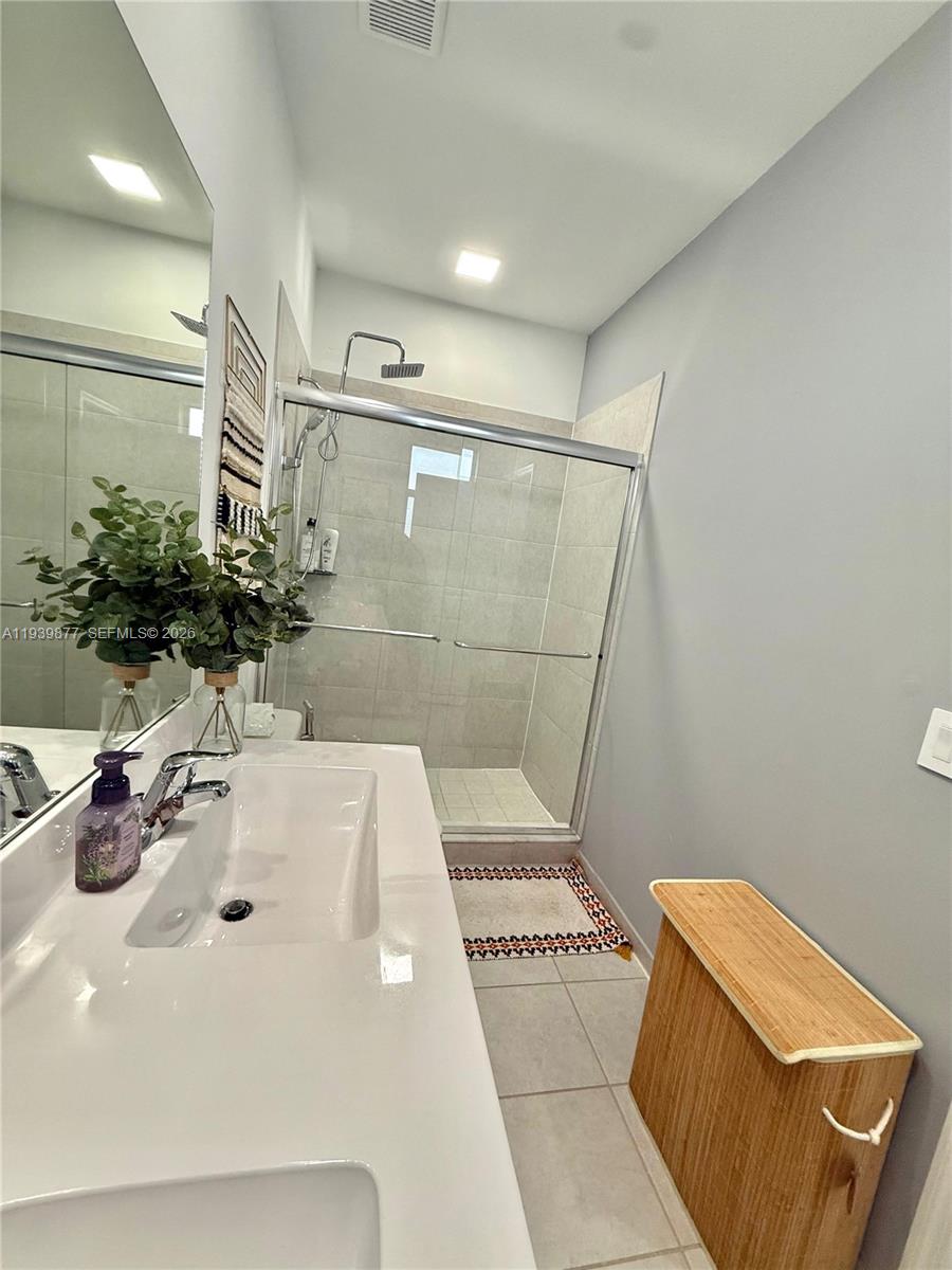 10066 Southwest 228th Terrace Miami, FL 33190 - Photo 14 of 42 a bathroom with a sink and a mirror