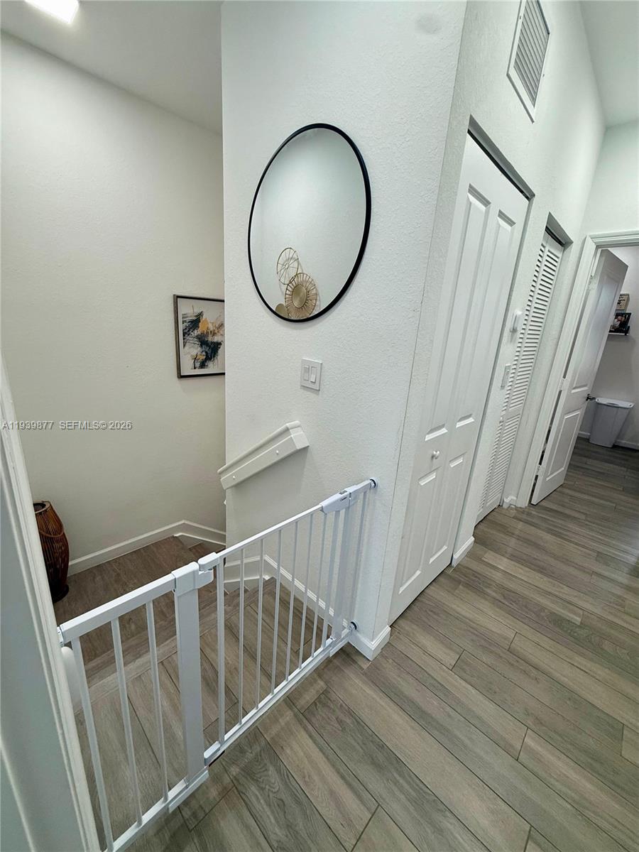 10066 Southwest 228th Terrace Miami, FL 33190 - Photo 19 of 42 a view of a hallway with wooden floor and staircase