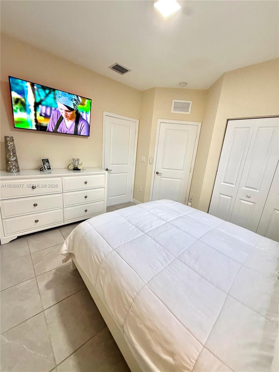 10066 Southwest 228th Terrace Miami, FL 33190 - Photo 20 of 42 a bedroom with a bed and a dresser