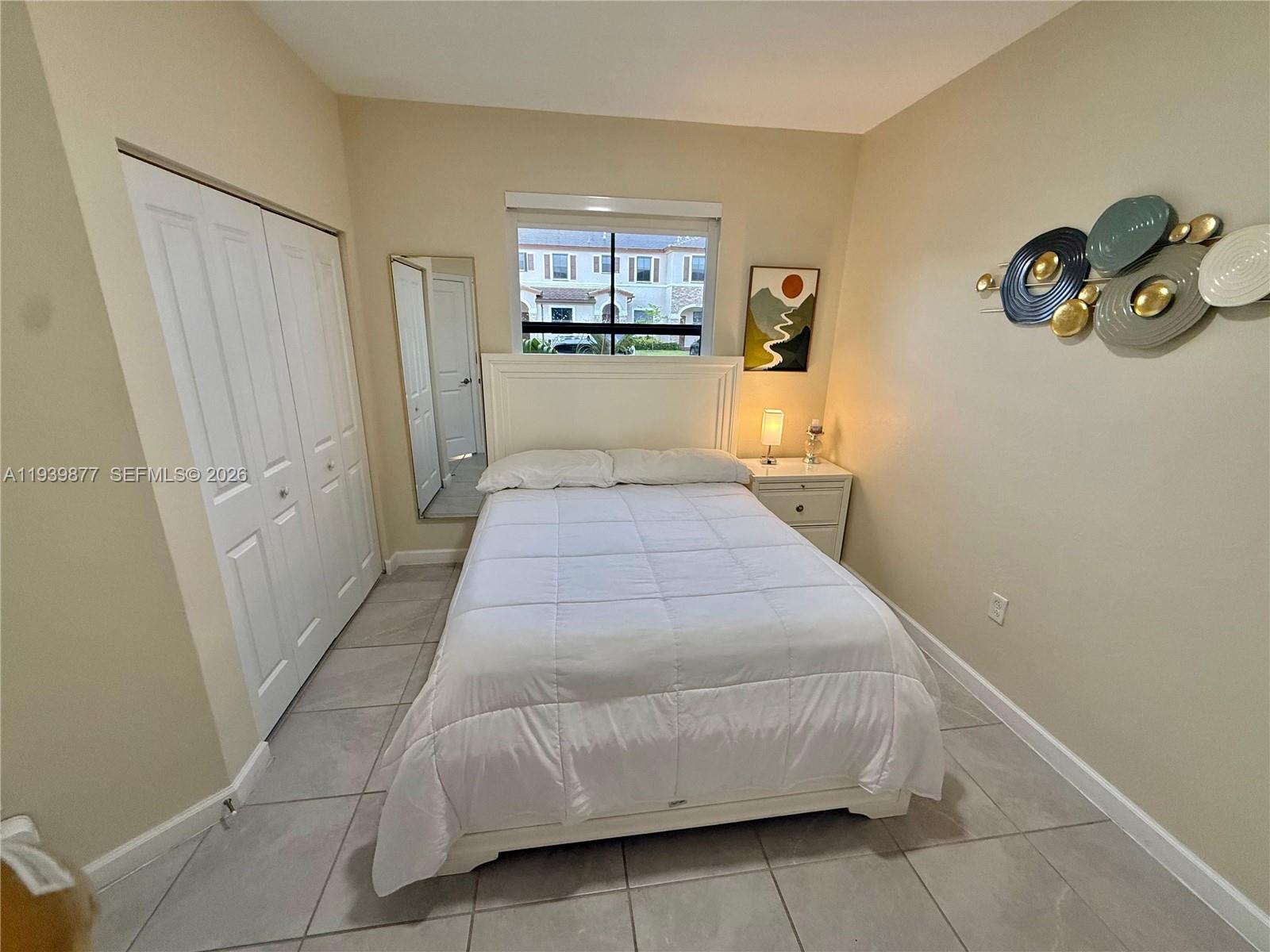 10066 Southwest 228th Terrace Miami, FL 33190 - Photo 27 of 42 a spacious bedroom with a bed and a large mirror