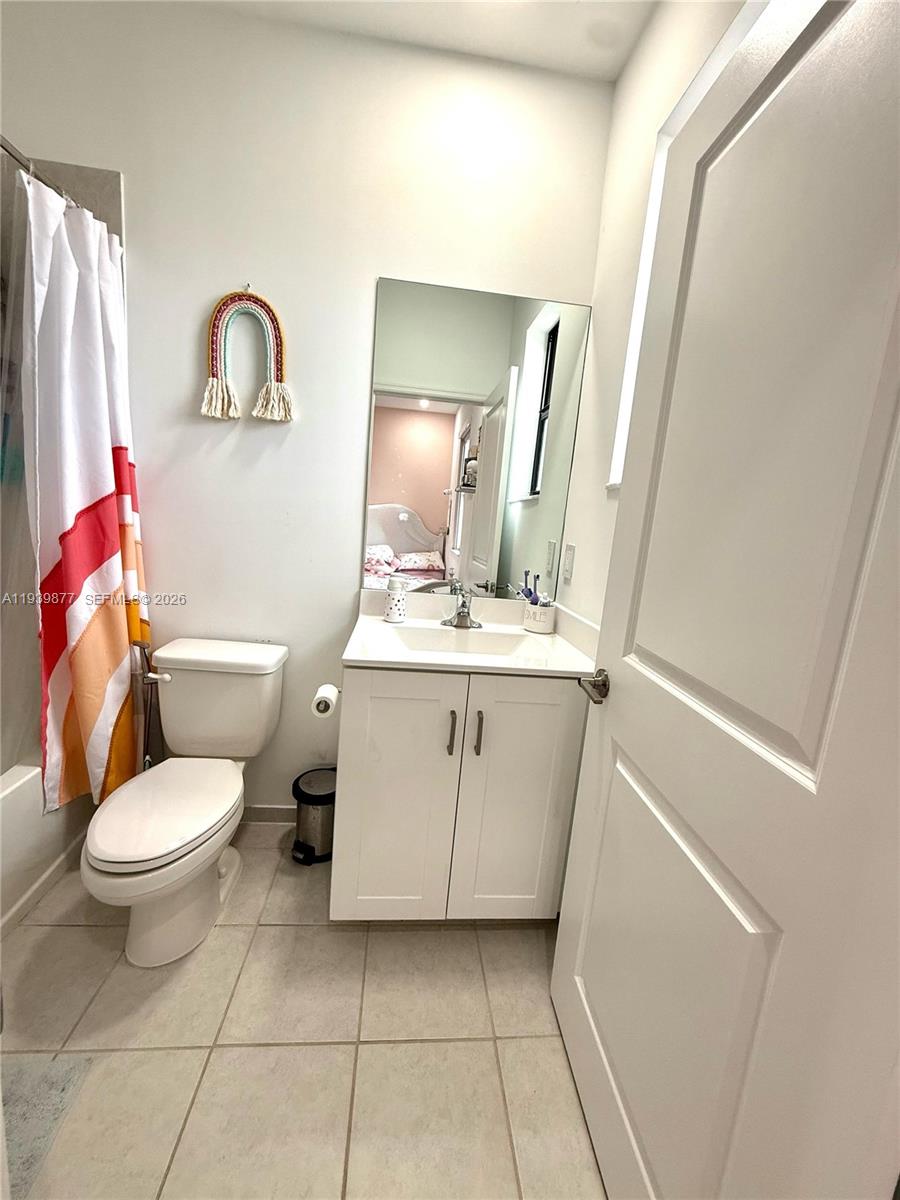 10066 Southwest 228th Terrace Miami, FL 33190 - Photo 29 of 42 a bathroom with a sink toilet and mirror