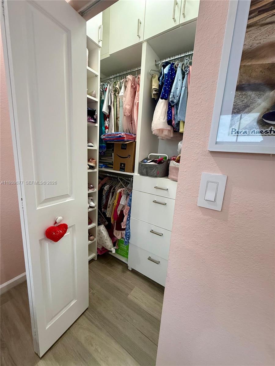 10066 Southwest 228th Terrace Miami, FL 33190 - Photo 31 of 42 a view of walk in closet with clothes and shoes