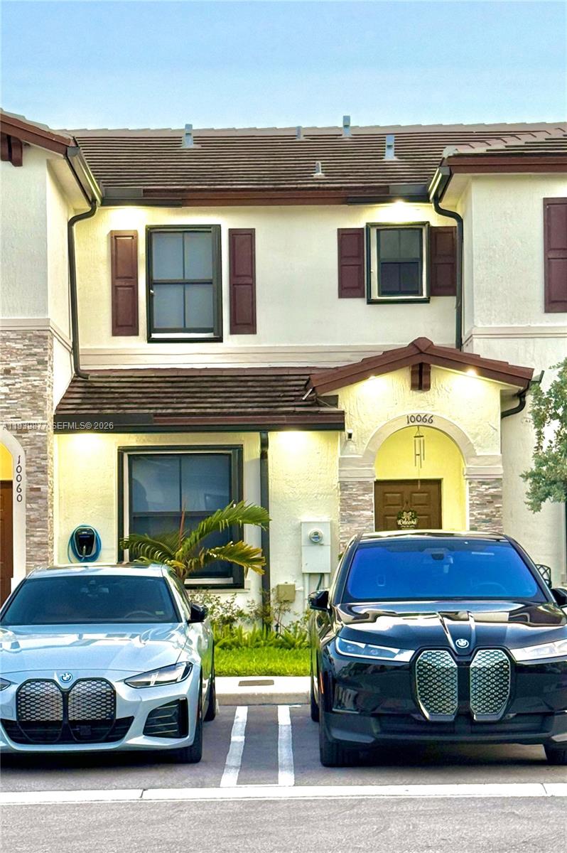 10066 Southwest 228th Terrace Miami, FL 33190 - Photo 40 of 42 a car parked in front of a house