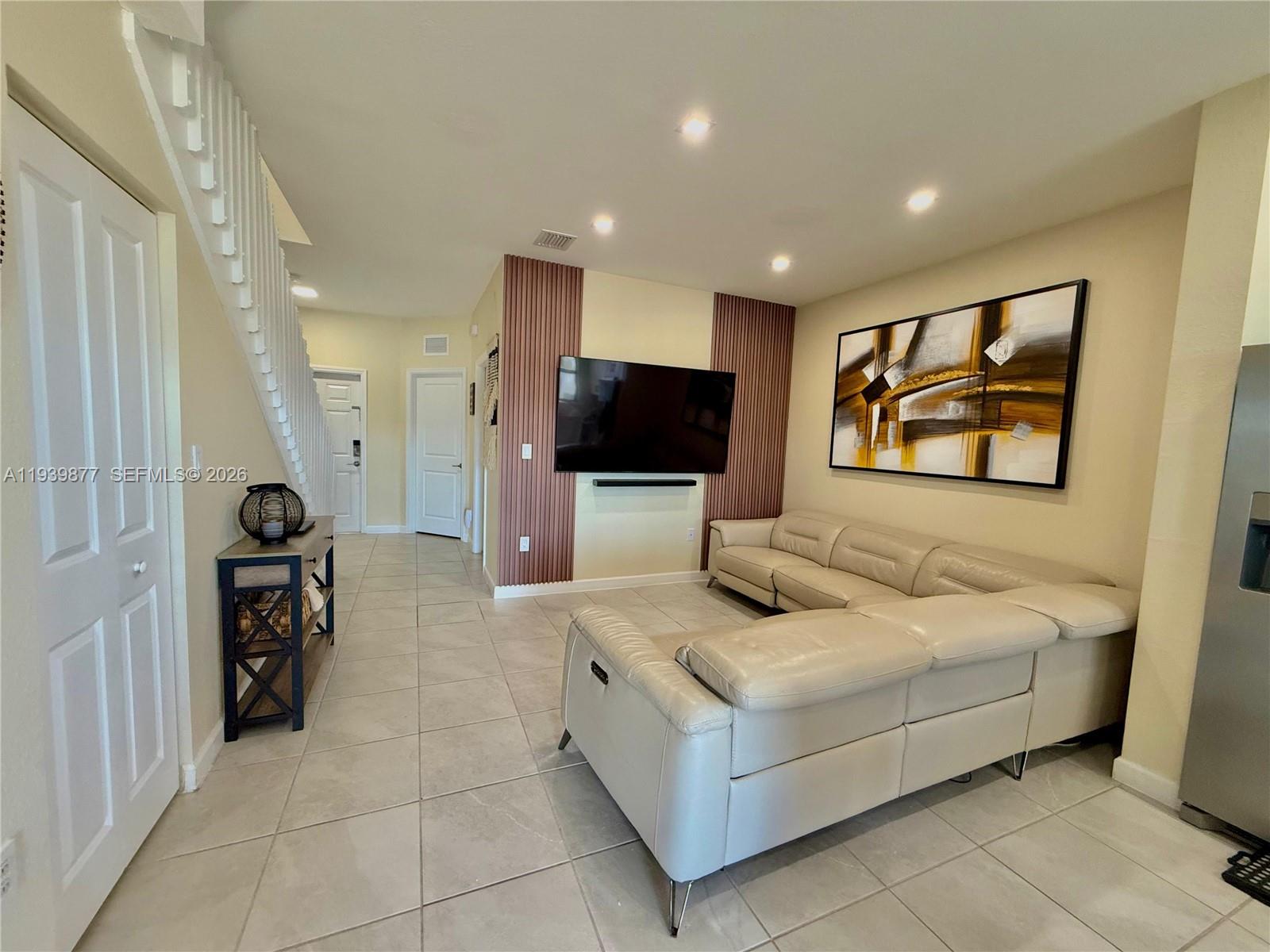 10066 Southwest 228th Terrace Miami, FL 33190 - Photo 9 of 42 a living room with furniture and a flat screen tv