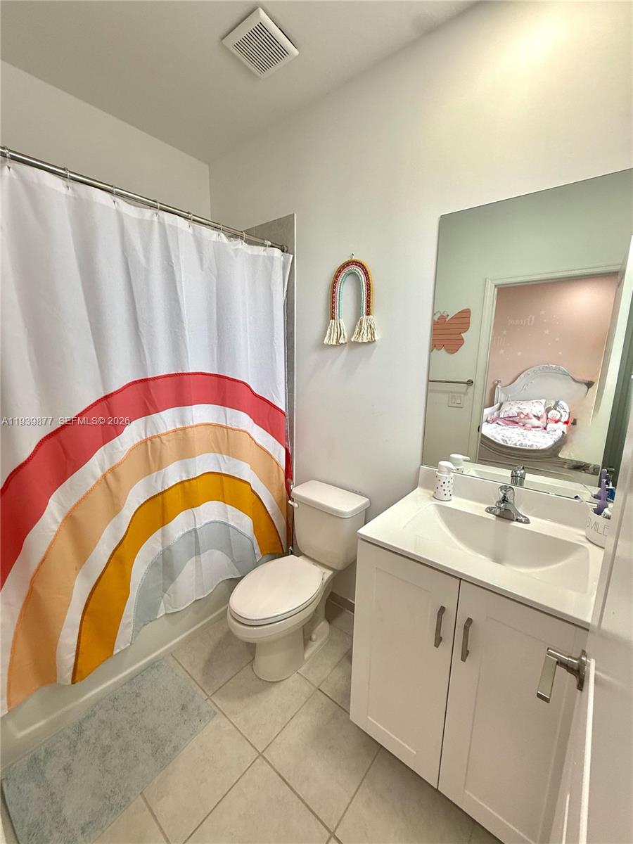 10066 Southwest 228th Terrace Miami, FL 33190 - Photo 10 of 42 a bathroom with a sink a mirror a toilet and a mirror