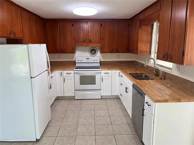 a kitchen with a stove sink and cabinets