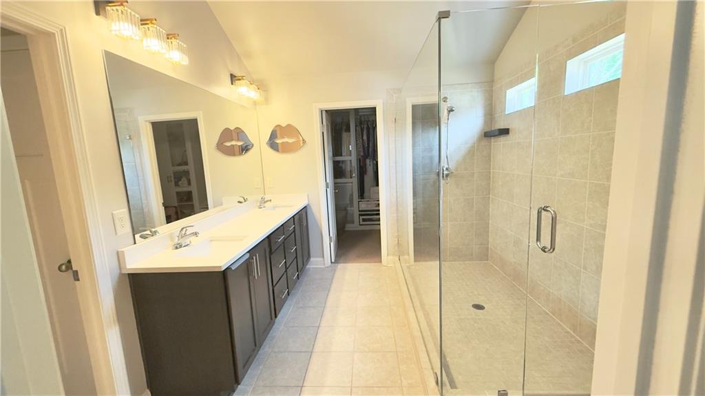 3370 Elkhorn Ridge Run Dacula, GA 30019 - Photo 19 of 29 a bathroom with a double vanity sink and mirror