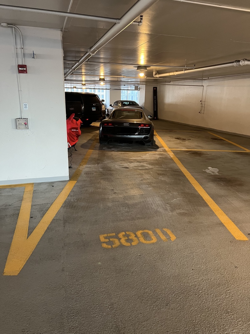 a view of parking garage with cars