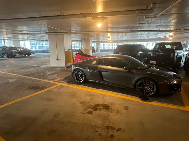 a view of parking garage with cars parked