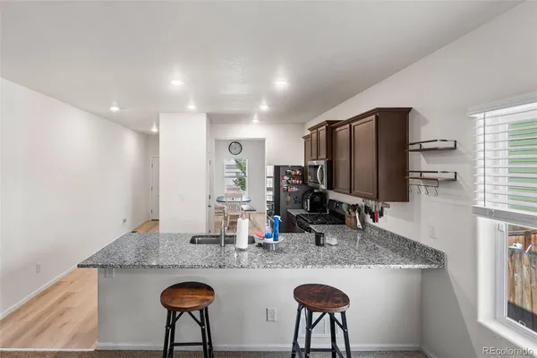 a kitchen with refrigerator and counter top space