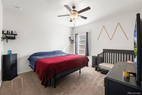 a spacious bedroom with a bed and a chandelier