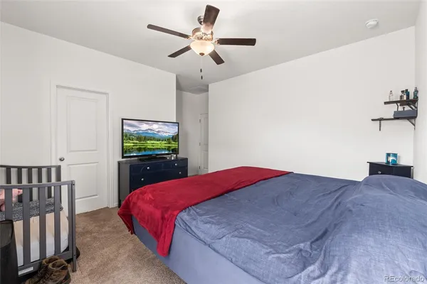 a bedroom with a bed and a chandelier