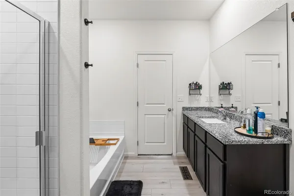 a bathroom with sink a mirror and shower