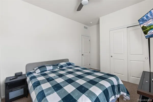 a bedroom with a bed and a lamp