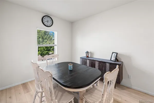 a view of a dining room with furniture and window