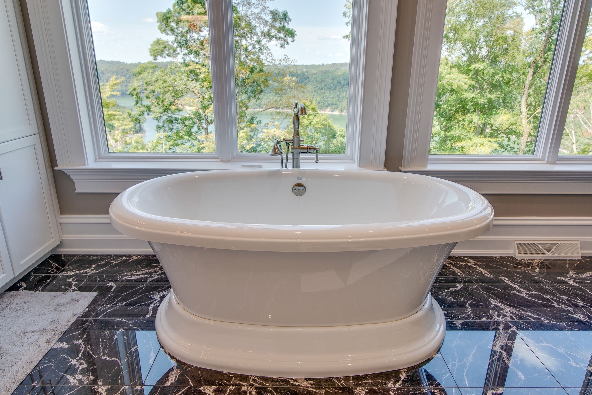5156 Turney Groce Road Byrdstown, TN 38549 - Photo 29 of 68 a white bath tub sitting in a bathroom next to a window