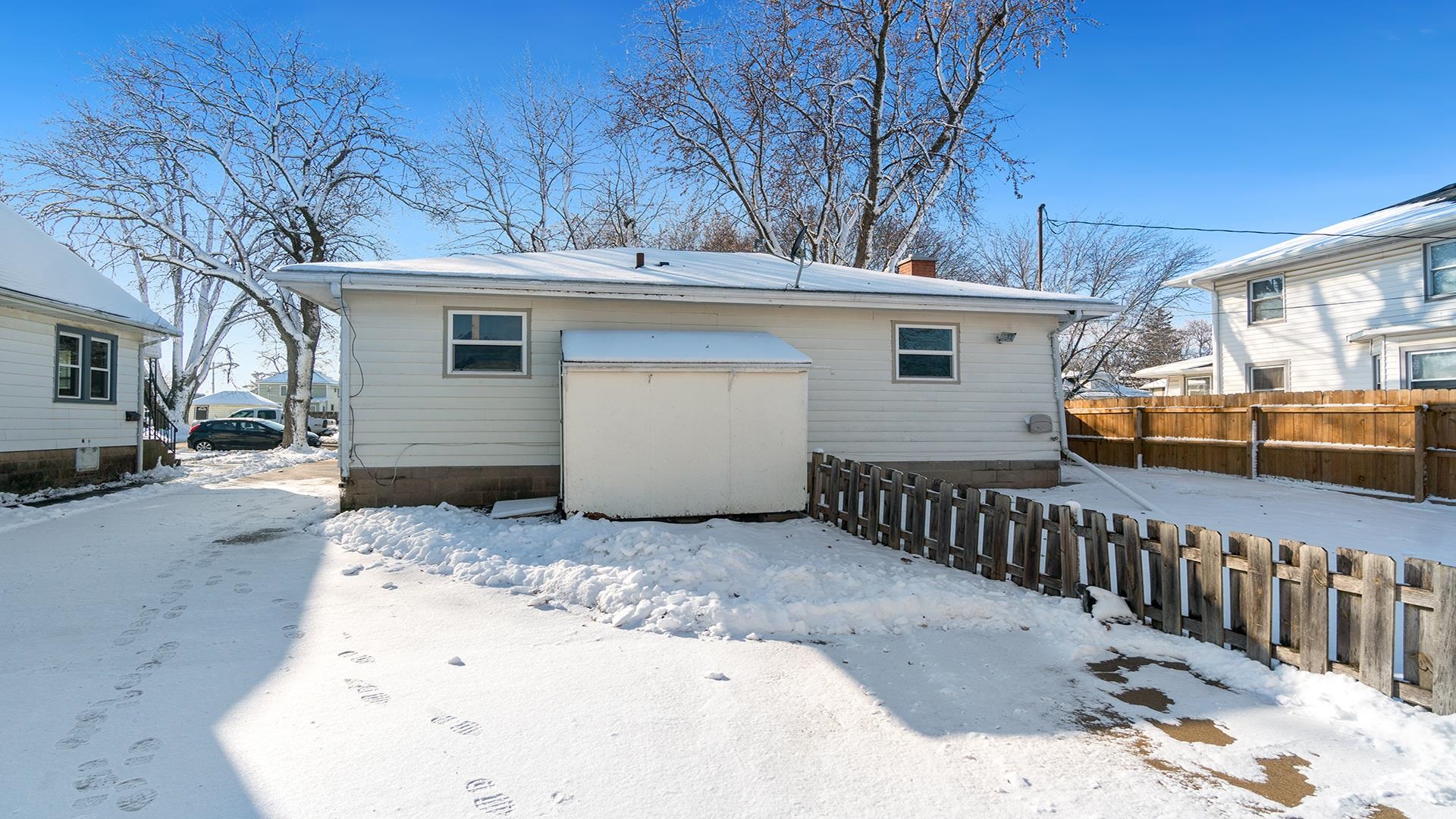 567 South 2nd Street Rochelle, IL 61068 - Photo 19 of 20 a view of a white house with a yard and wooden fence