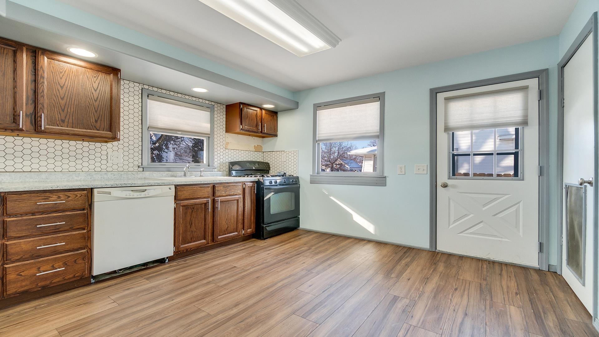 567 South 2nd Street Rochelle, IL 61068 - Photo 7 of 20 a kitchen with stainless steel appliances a white stove top oven and a wooden floors