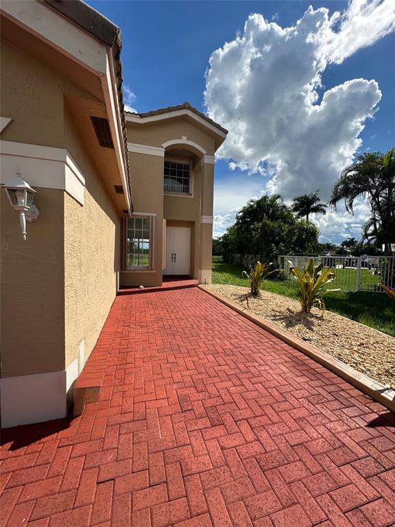 13376 Southwest 47th Street Miramar, FL 33027 - Photo 2 of 38 a front view of a house with a yard