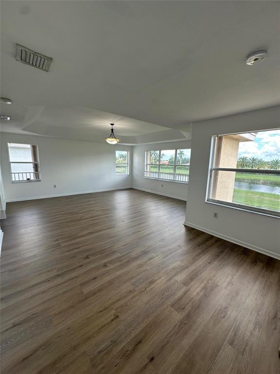 13376 Southwest 47th Street Miramar, FL 33027 - Photo 22 of 38 an empty room with wooden floor and windows