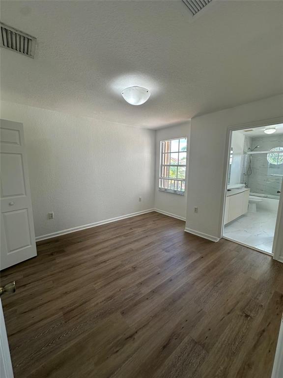 13376 Southwest 47th Street Miramar, FL 33027 - Photo 26 of 38 an empty room with wooden floor and windows
