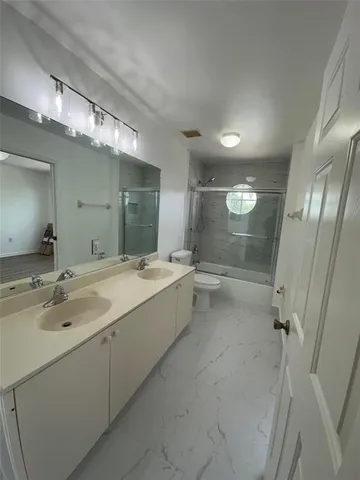 a bathroom with a tub sink shower and mirror