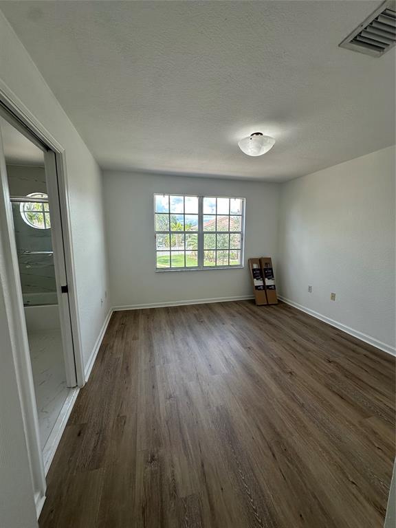 13376 Southwest 47th Street Miramar, FL 33027 - Photo 29 of 38 wooden floor in an empty room with a window