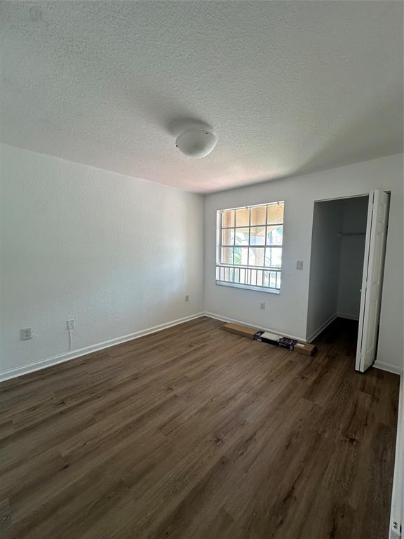 13376 Southwest 47th Street Miramar, FL 33027 - Photo 32 of 38 an empty room with wooden floor and windows