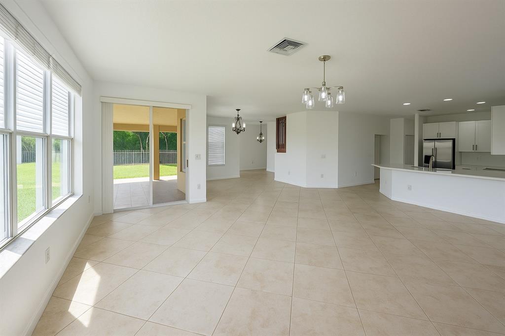 13376 Southwest 47th Street Miramar, FL 33027 - Photo 6 of 38 a view of a big room with windows and chandelier