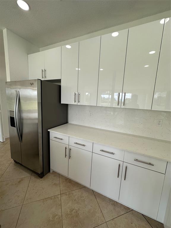 13376 Southwest 47th Street Miramar, FL 33027 - Photo 7 of 38 a kitchen with cabinets and stainless steel appliances