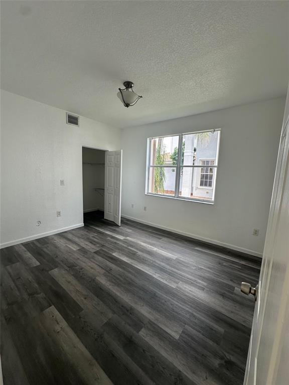 13376 Southwest 47th Street Miramar, FL 33027 - Photo 10 of 38 a view of an empty room with wooden floor and a window
