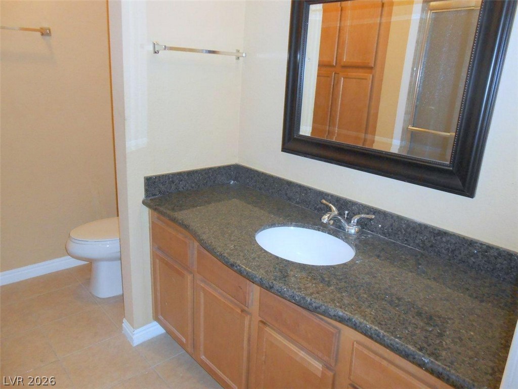 9325 West Desert Inn Road, Unit 132 Las Vegas, NV 89117 - Photo 9 of 36 A refined bathroom featuring a spacious vanity with elegant granite countertops.