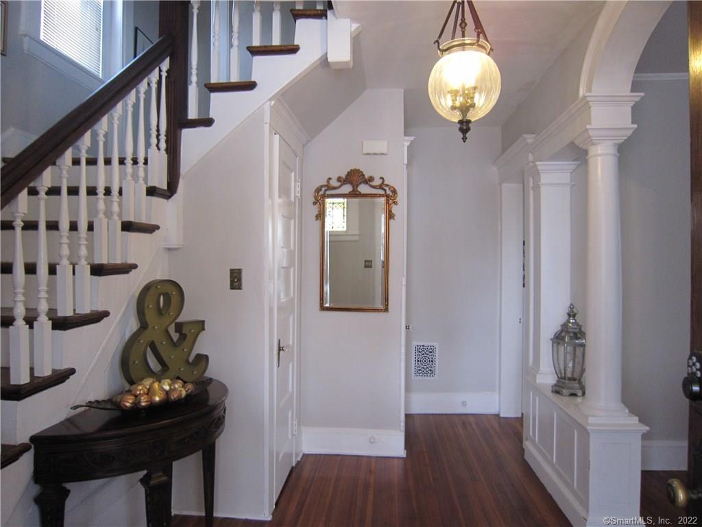 a view of a hallway to dining room and wooden floor